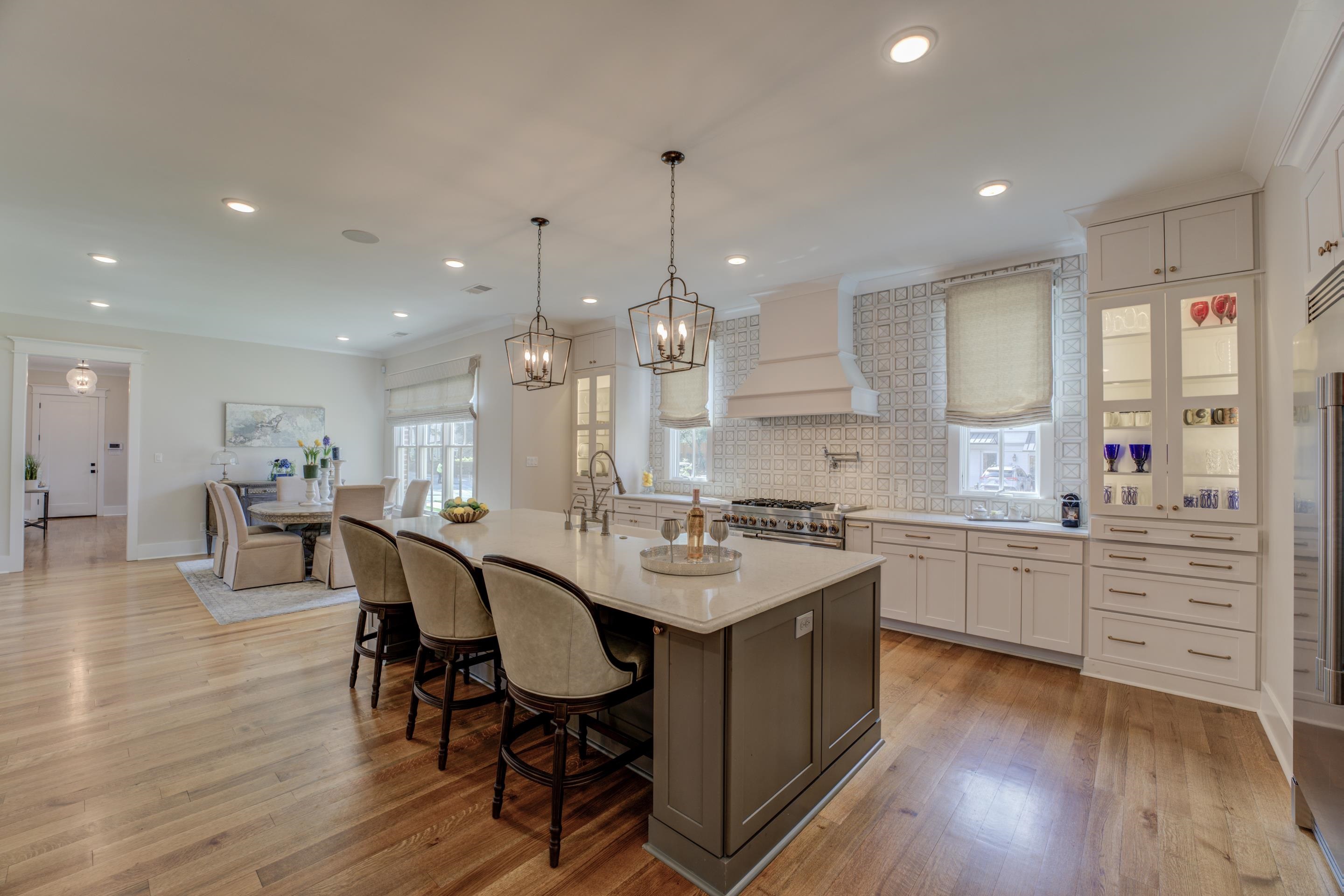 112 North Mt Pleasant Road Collierville, TN 38017 - Photo 11 of 40 a kitchen with counter space dining table chairs sink and cabinets