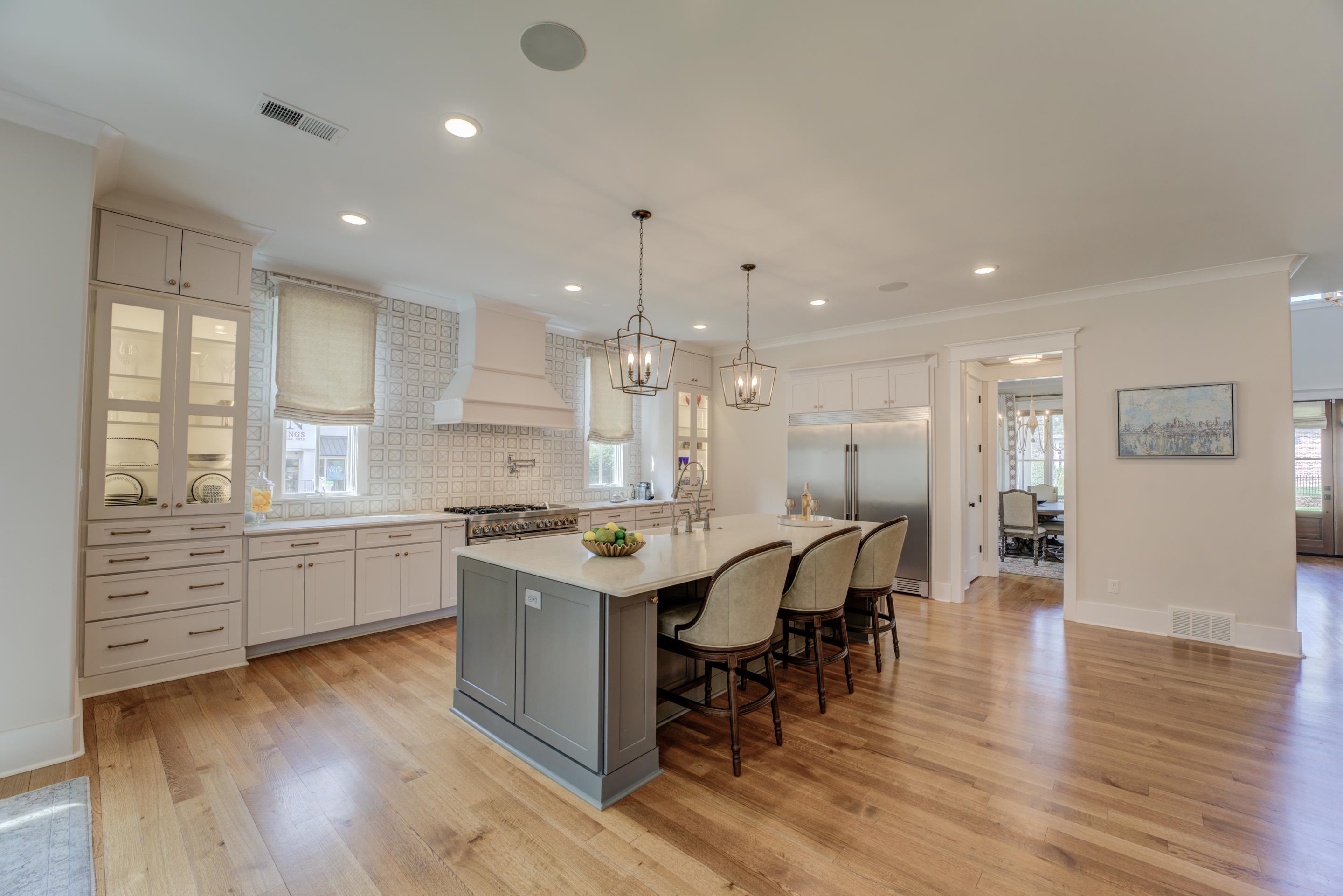 112 North Mt Pleasant Road Collierville, TN 38017 - Photo 12 of 40 a kitchen with stainless steel appliances granite countertop a table chairs stove a sink dishwasher and cabinets with wooden floor
