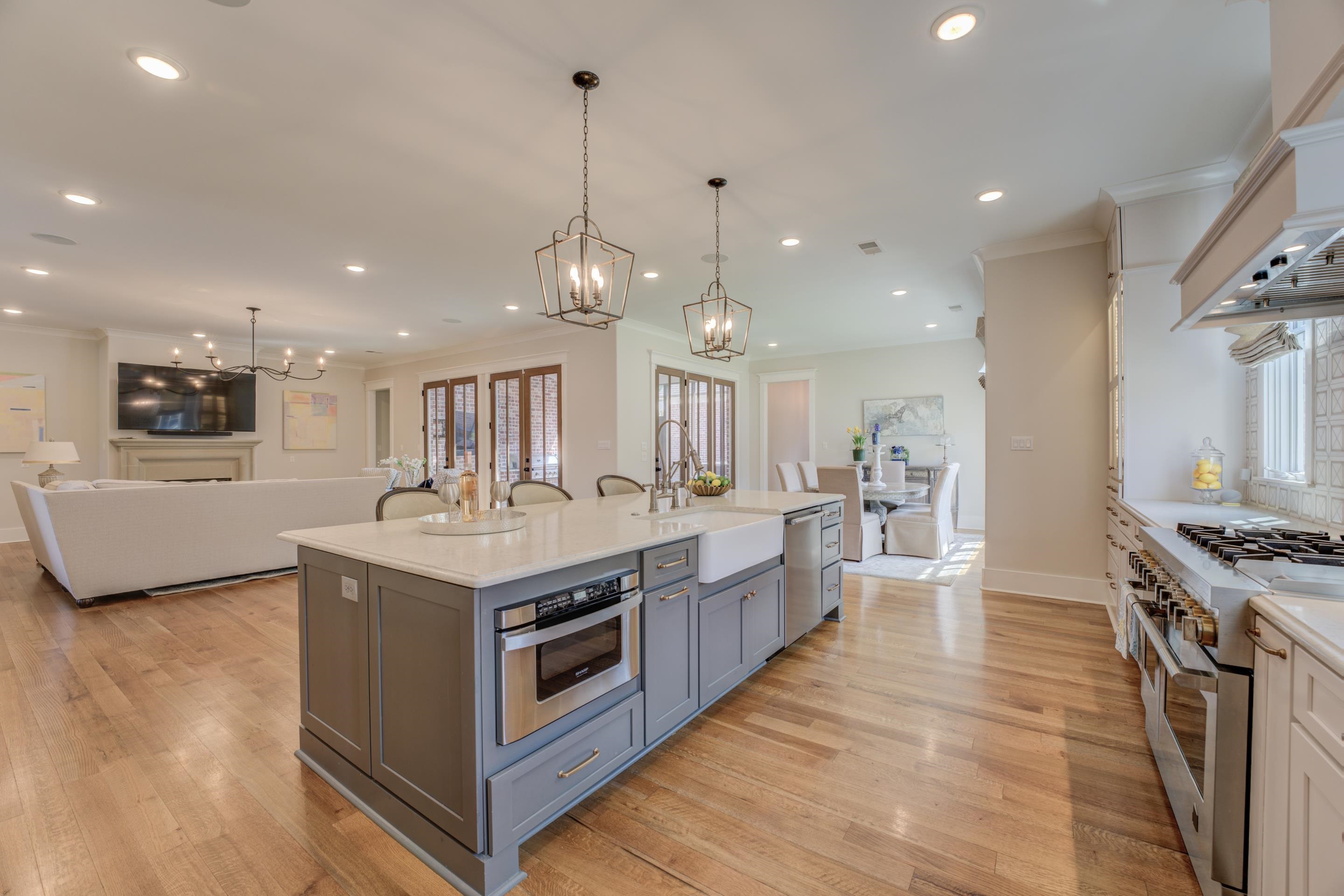 112 North Mt Pleasant Road Collierville, TN 38017 - Photo 14 of 40 a kitchen with stainless steel appliances granite countertop a sink stove and a wooden floors