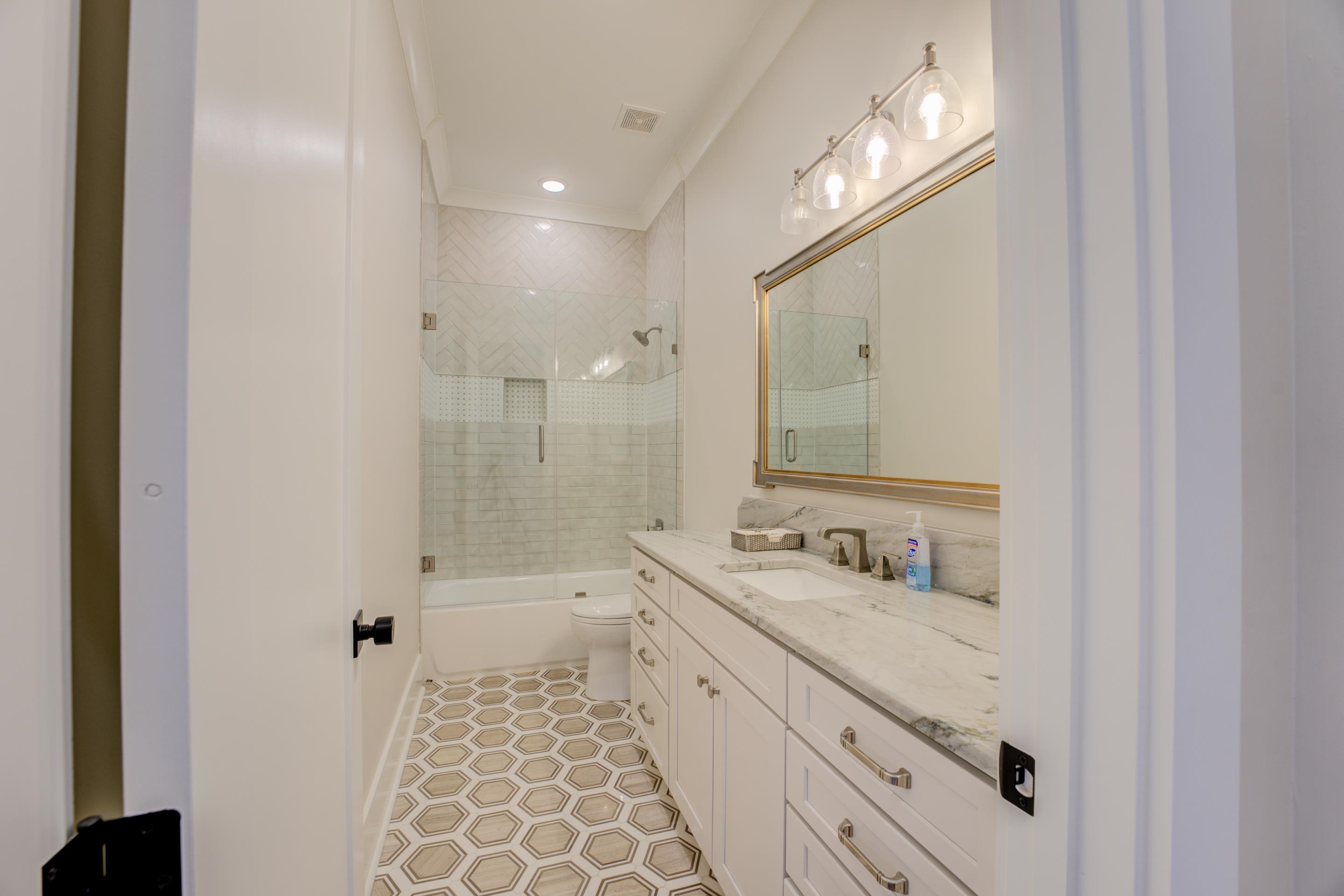 112 North Mt Pleasant Road Collierville, TN 38017 - Photo 25 of 40 a bathroom with a double vanity sink a toilet a mirror and shower