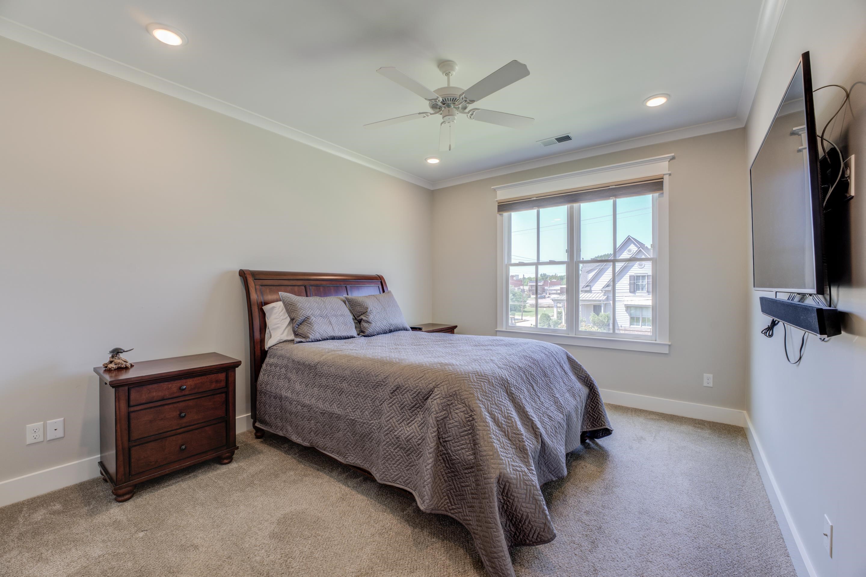 112 North Mt Pleasant Road Collierville, TN 38017 - Photo 30 of 40 a spacious bedroom with a bed and a flat screen tv