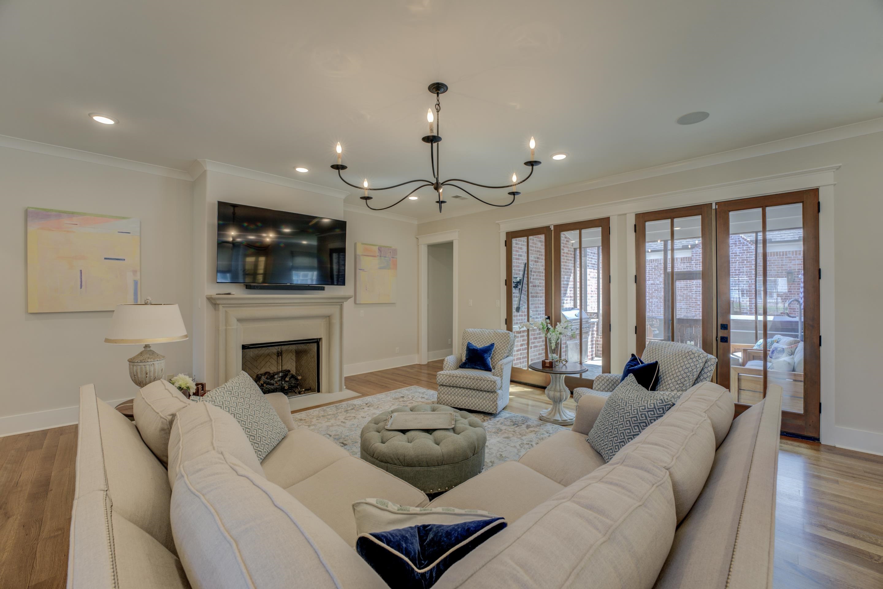 112 North Mt Pleasant Road Collierville, TN 38017 - Photo 9 of 40 a living room with furniture a fireplace and a flat screen tv