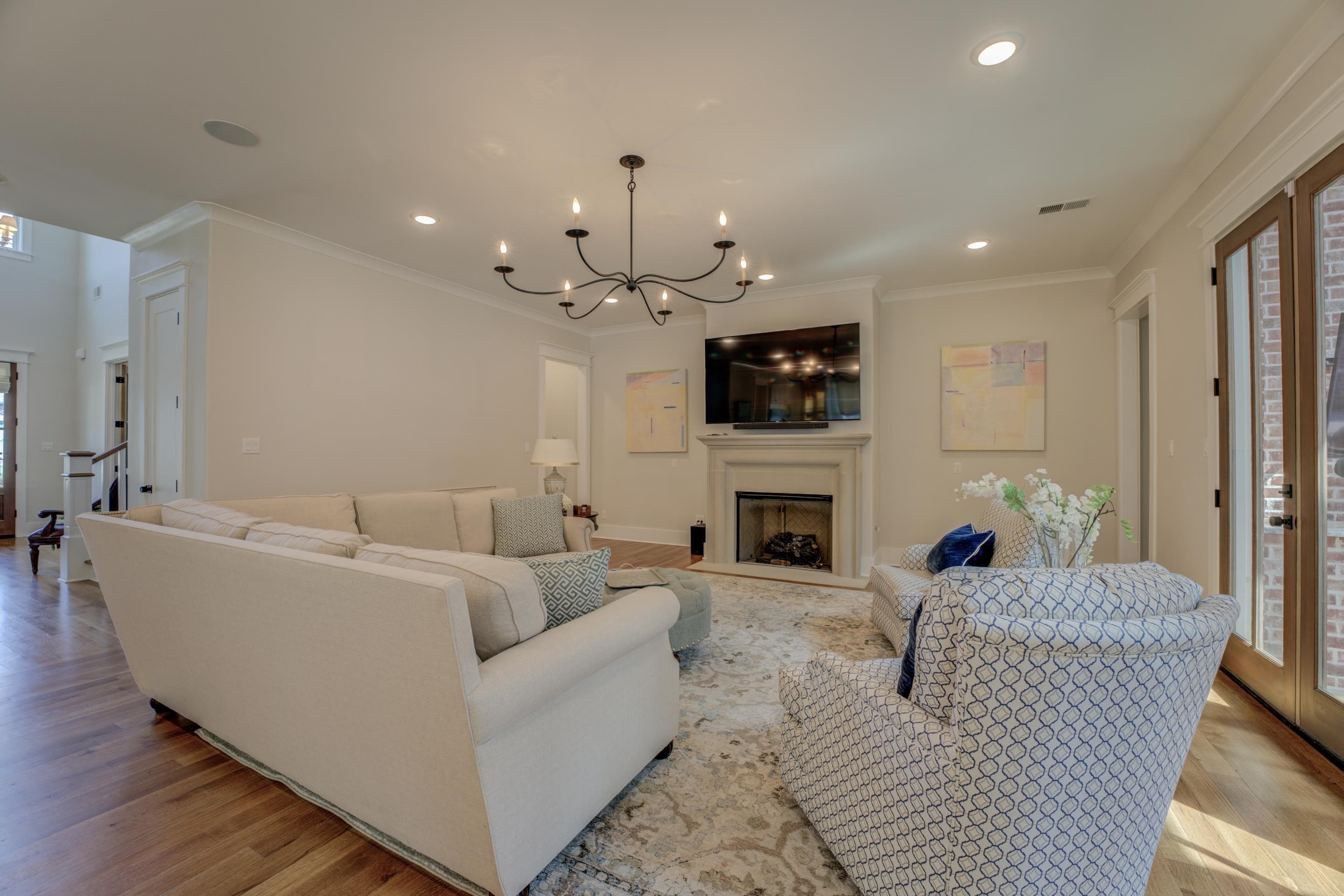 112 North Mt Pleasant Road Collierville, TN 38017 - Photo 10 of 40 a living room with furniture a fireplace and a chandelier