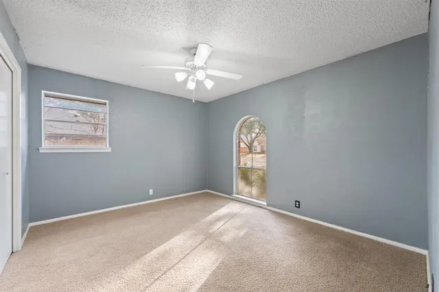 a bathroom with a granite countertop sink toilet and mirror
