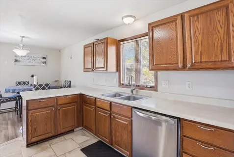 a kitchen with a sink cabinets and window