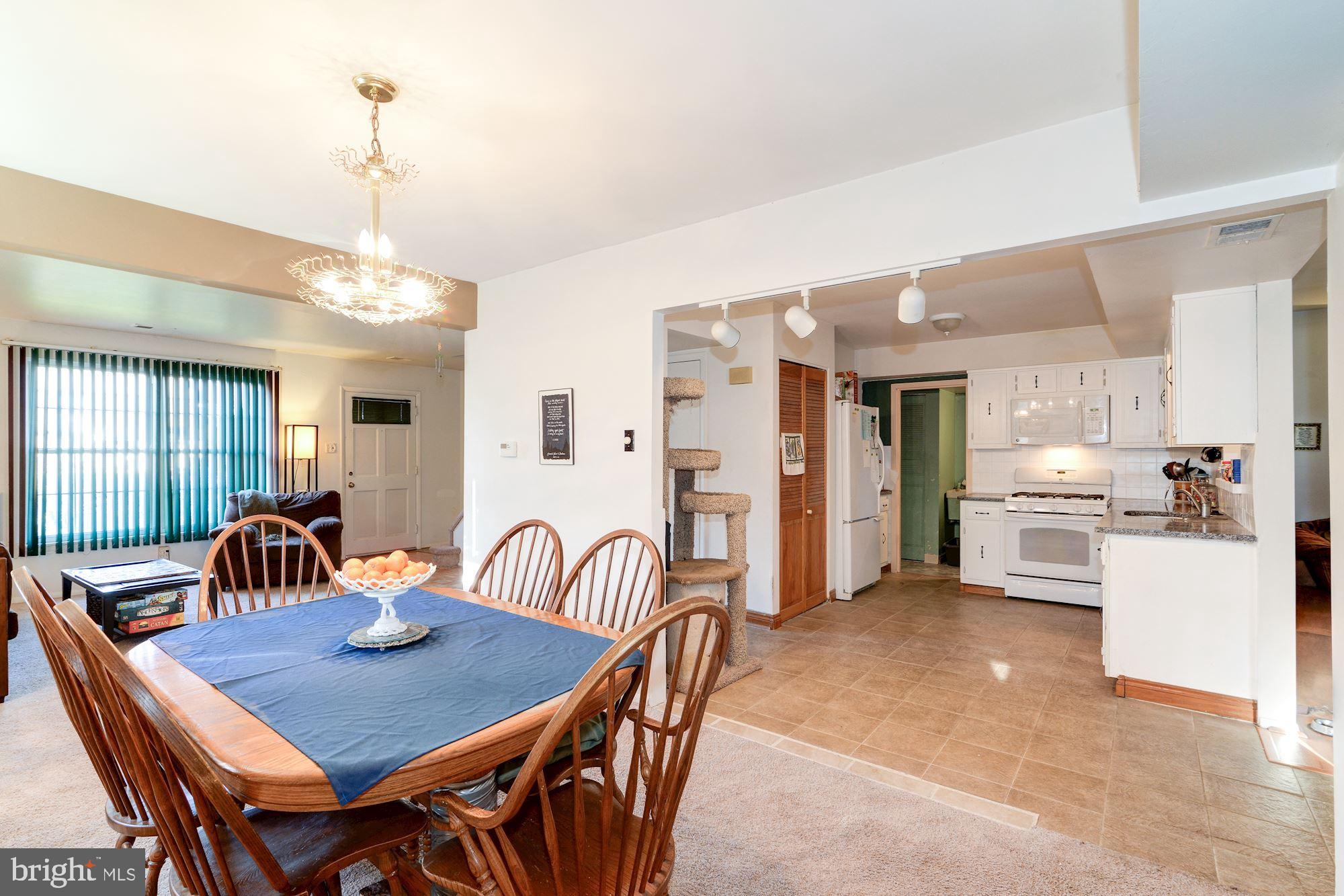 1604 Coventry Place Clementon, NJ 08021 - Photo 13 of 45 a view of a dining room and livingroom with furniture a rug and a chandelier