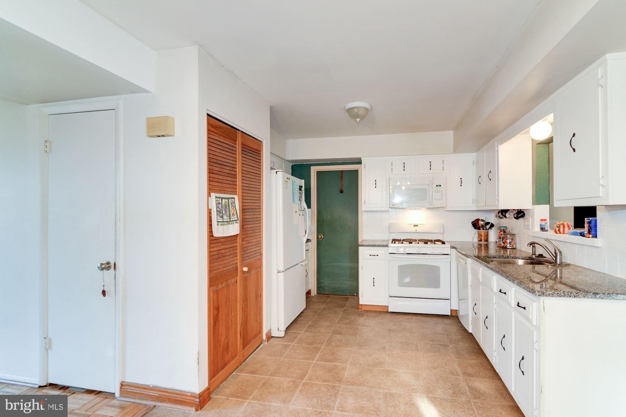 1604 Coventry Place Clementon, NJ 08021 - Photo 15 of 45 a kitchen with granite countertop a sink stove and refrigerator