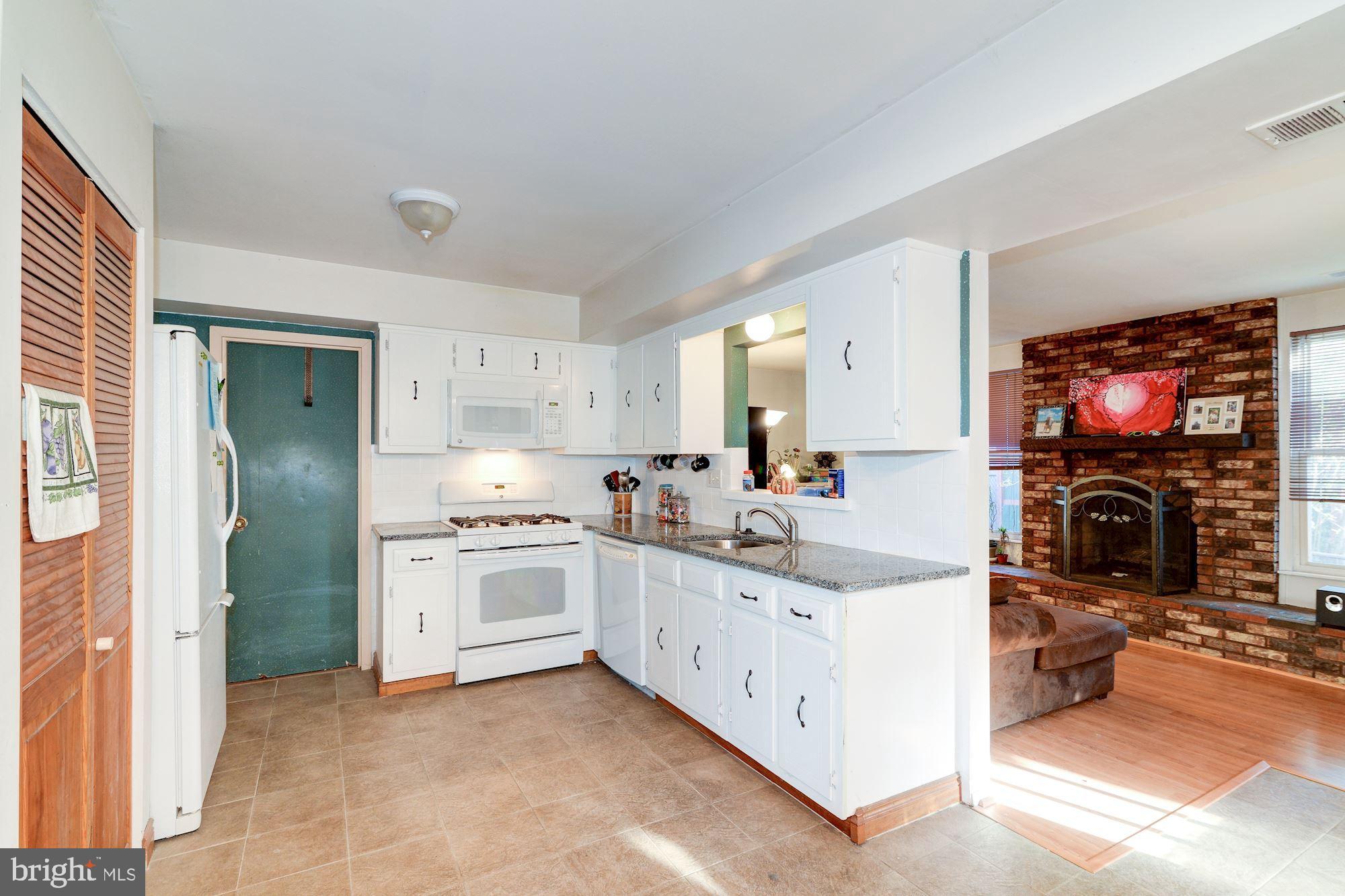 1604 Coventry Place Clementon, NJ 08021 - Photo 17 of 45 a kitchen with stainless steel appliances granite countertop a stove top oven a sink and a refrigerator