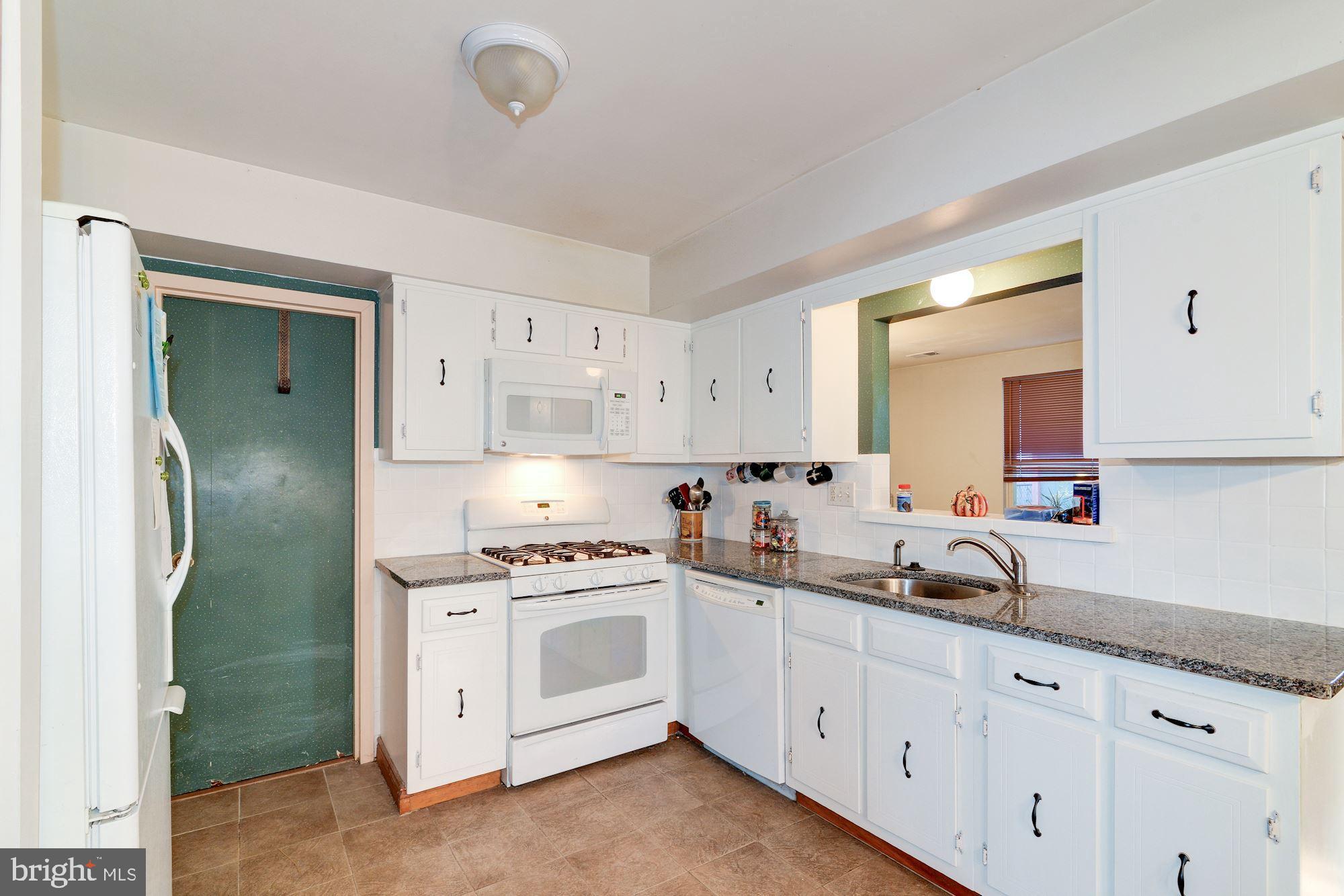 1604 Coventry Place Clementon, NJ 08021 - Photo 18 of 45 a kitchen with white cabinets and white appliances