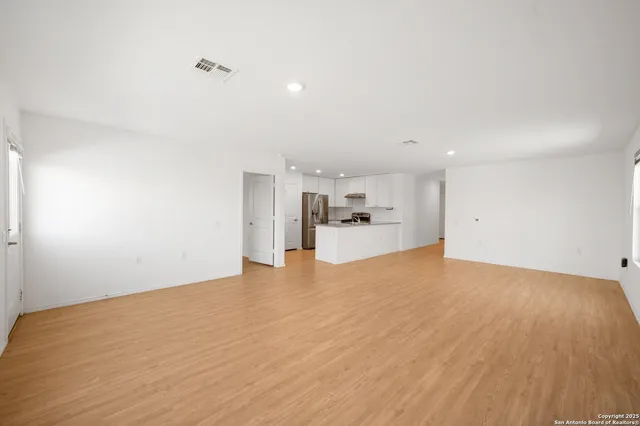 a view of a kitchen with a sink and a refrigerator