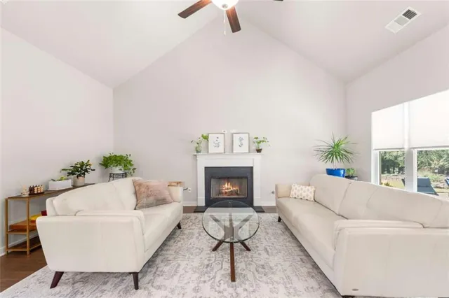 a living room with furniture fireplace and window