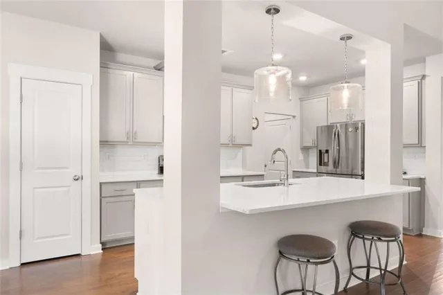 a view of a kitchen with a sink and chandelier