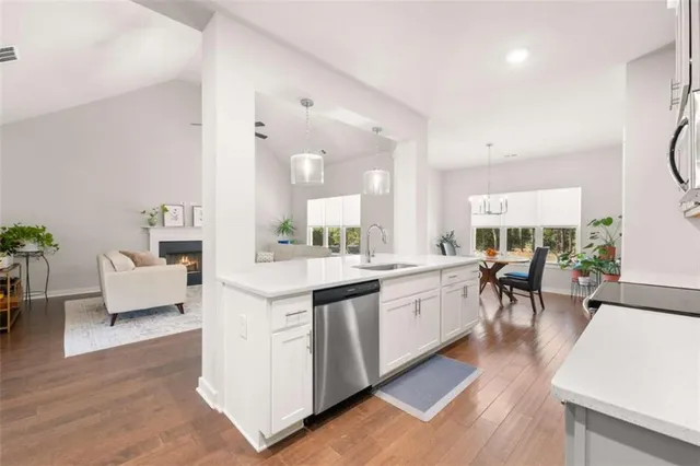 a large white kitchen with lots of counter space and furniture