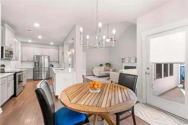 a living room with furniture a kitchen island dining table and chairs