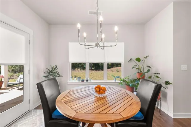a view of a dining room with furniture window and wooden floor