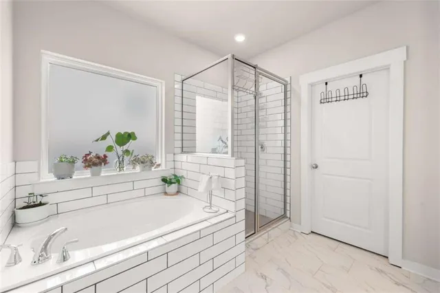 a white bath tub sitting next to a white tub