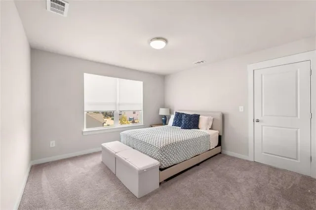 a spacious bedroom with a bed and a large window