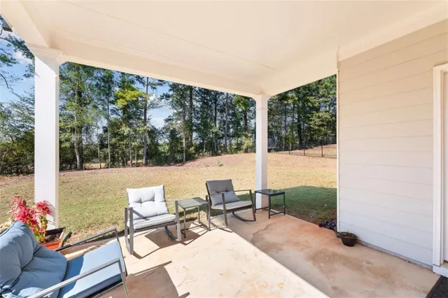a view of a patio with a dining table and chairs