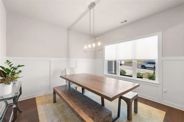 a view of a dining room with furniture window and wooden floor