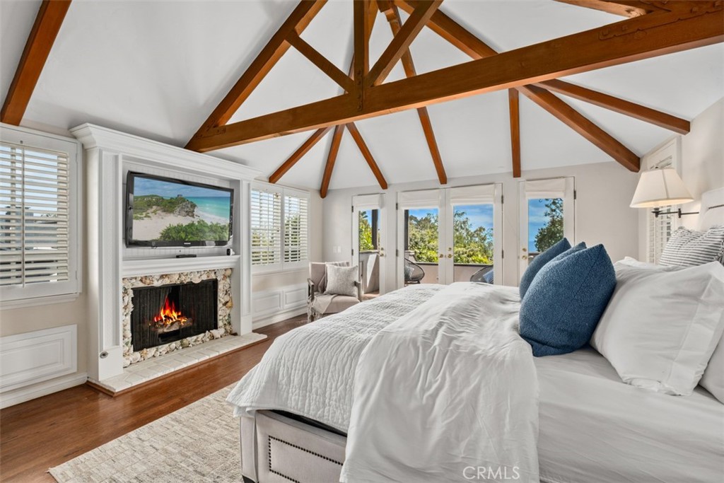 421 High Drive Laguna Beach, CA 92651 - Photo 18 of 42 a bedroom with a bed and a fireplace