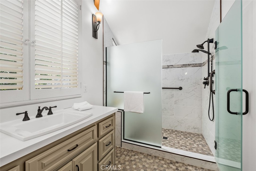 421 High Drive Laguna Beach, CA 92651 - Photo 25 of 42 a bathroom with a shower sink and mirror