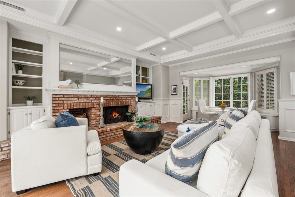 421 High Drive Laguna Beach, CA 92651 - Photo 29 of 42 a living room with furniture a fireplace and a floor to ceiling window