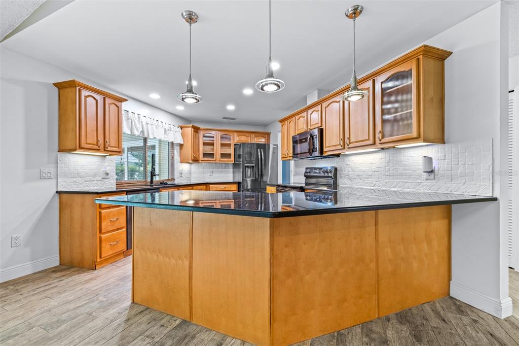 3404 Brian Road South Palm Harbor, FL 34685 - Photo 12 of 71 a kitchen with stainless steel appliances granite countertop a sink and wooden cabinets