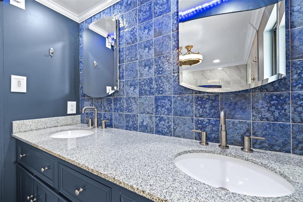 3404 Brian Road South Palm Harbor, FL 34685 - Photo 31 of 71 a bathroom with a granite countertop sink a mirror and vanity