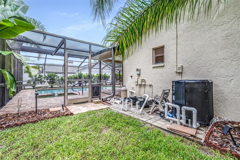 3404 Brian Road South Palm Harbor, FL 34685 - Photo 60 of 71 a view of a patio with table and chairs potted plants and palm tree