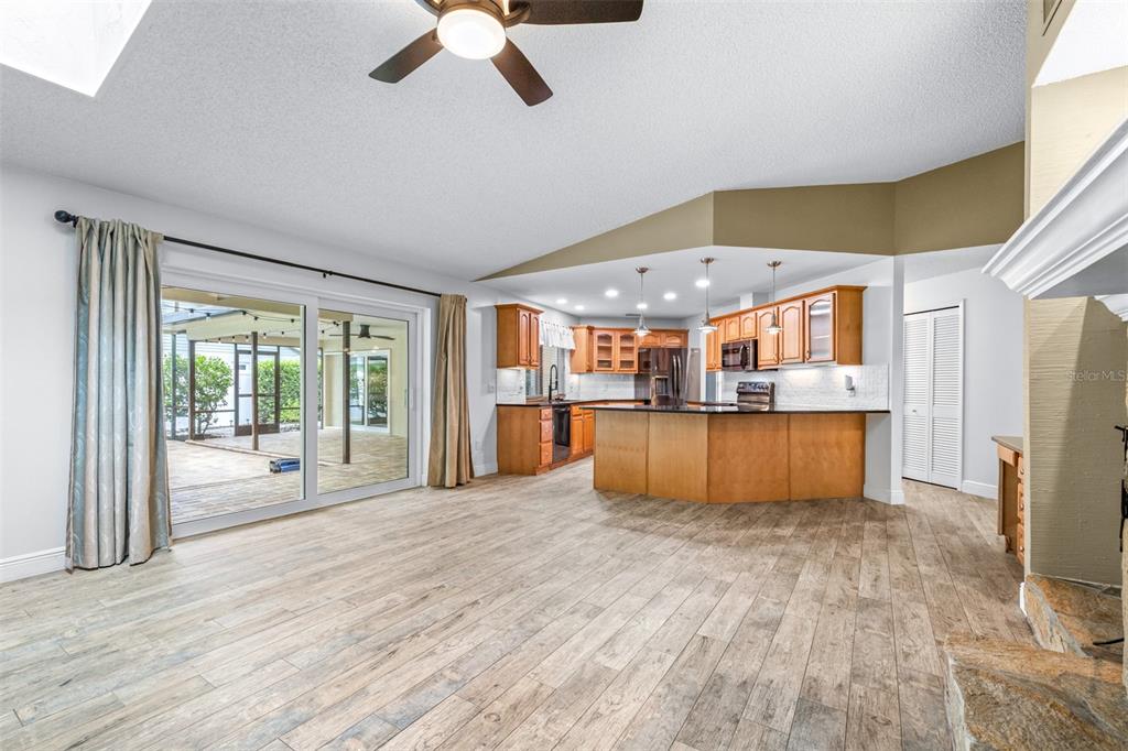3404 Brian Road South Palm Harbor, FL 34685 - Photo 6 of 71 a view of a kitchen with a sink dishwasher a kitchen view with wooden floor and cabinets