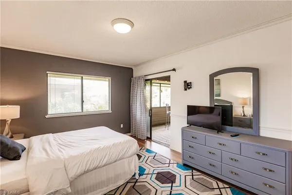 a bedroom with a bed and a television