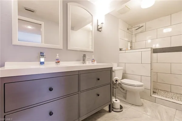 a bathroom with a sink toilet and shower