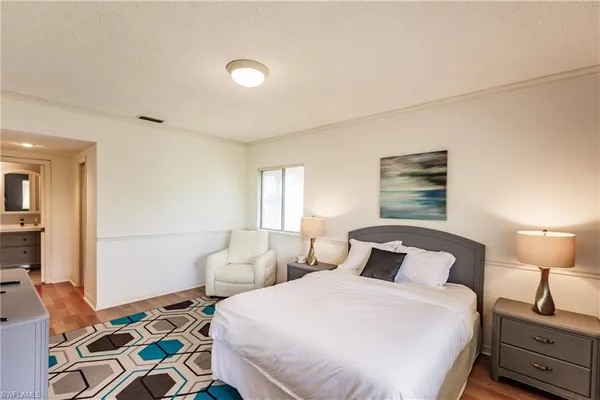 a bedroom with a bed and a lamp