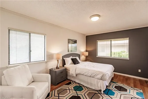 a bedroom with furniture and a window