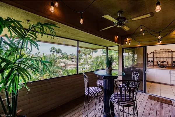 a view of a porch with furniture and a yard