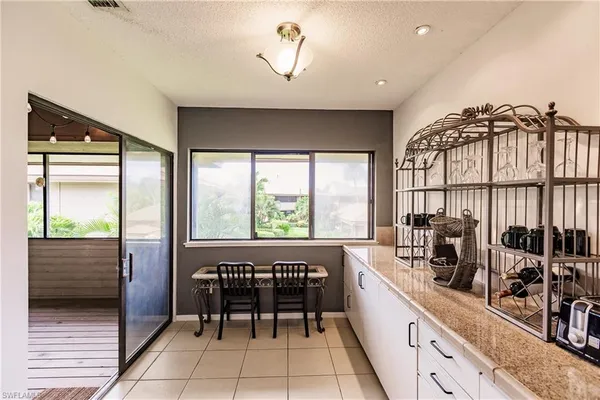 a kitchen with a large window appliances and cabinets