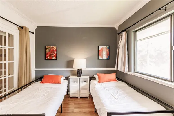 a bedroom with a bed and a large window