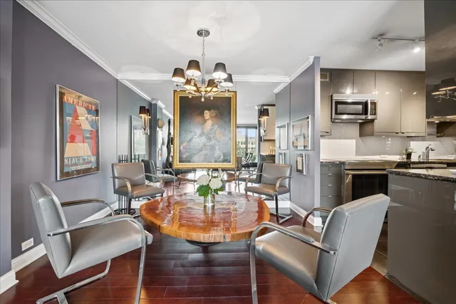 a dining room with wooden floor a glass table and chairs