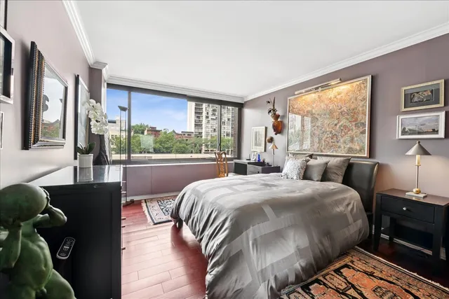 a bedroom with a large bed and a window