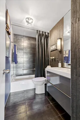 a bathroom with a sink toilet a mirror and shower