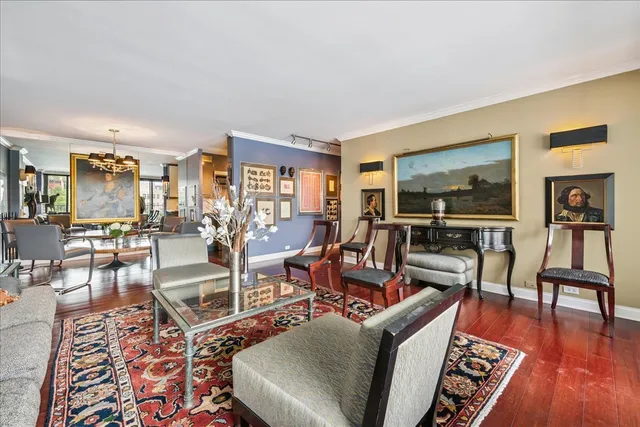 a view of a dining room with furniture a rug and wooden floor