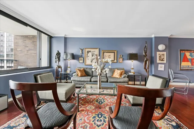 a living room with furniture and a floor to ceiling window