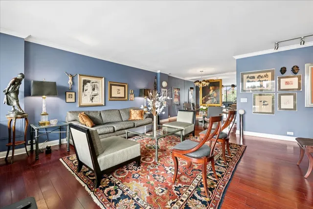 a kitchen with stainless steel appliances granite countertop a refrigerator a sink dishwasher a stove and a dining table with wooden floor