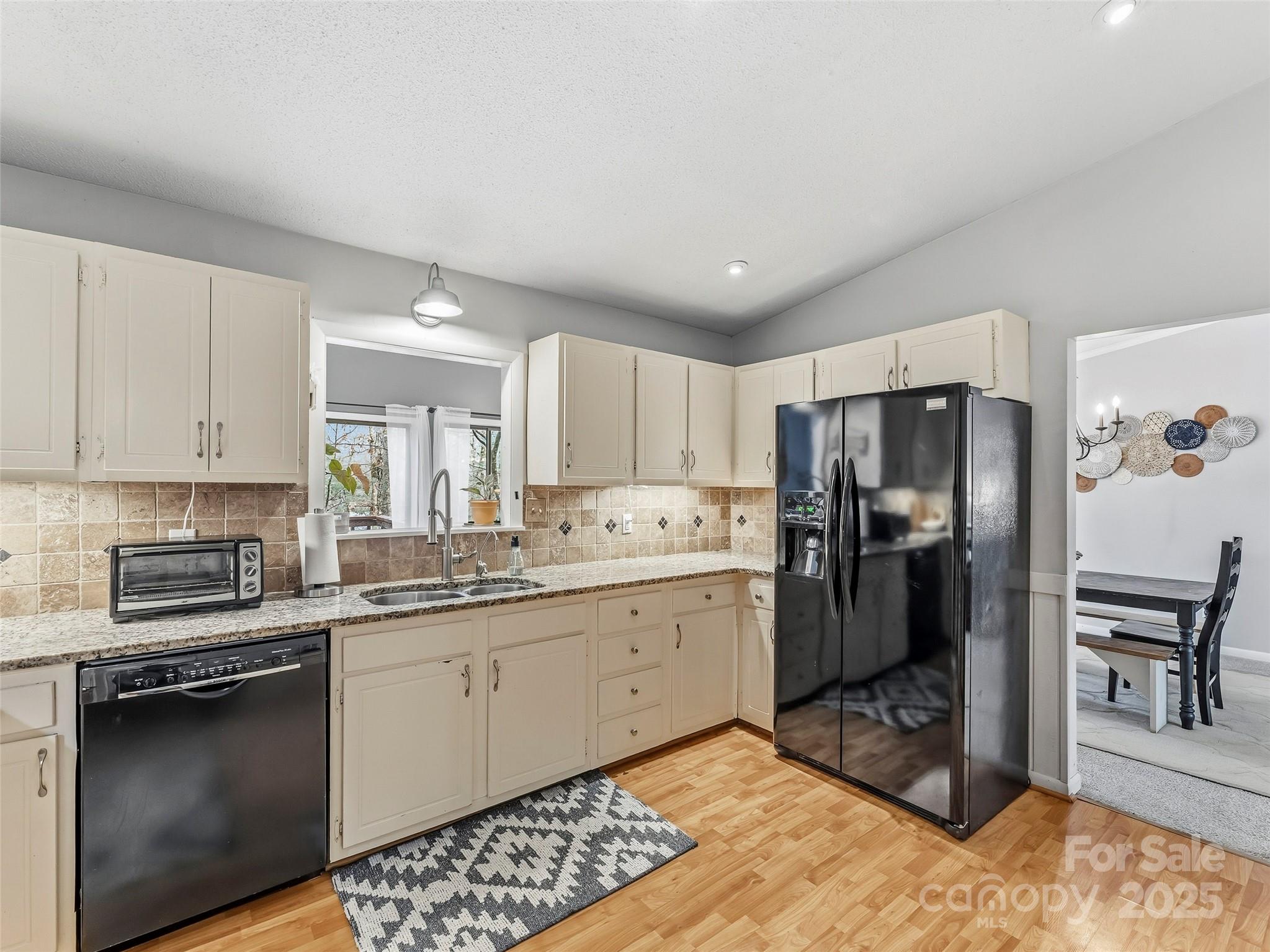531 Three Mile Knob Road Pisgah Forest, NC 28768 - Photo 12 of 37 a kitchen with a sink cabinets stainless steel appliances and a window