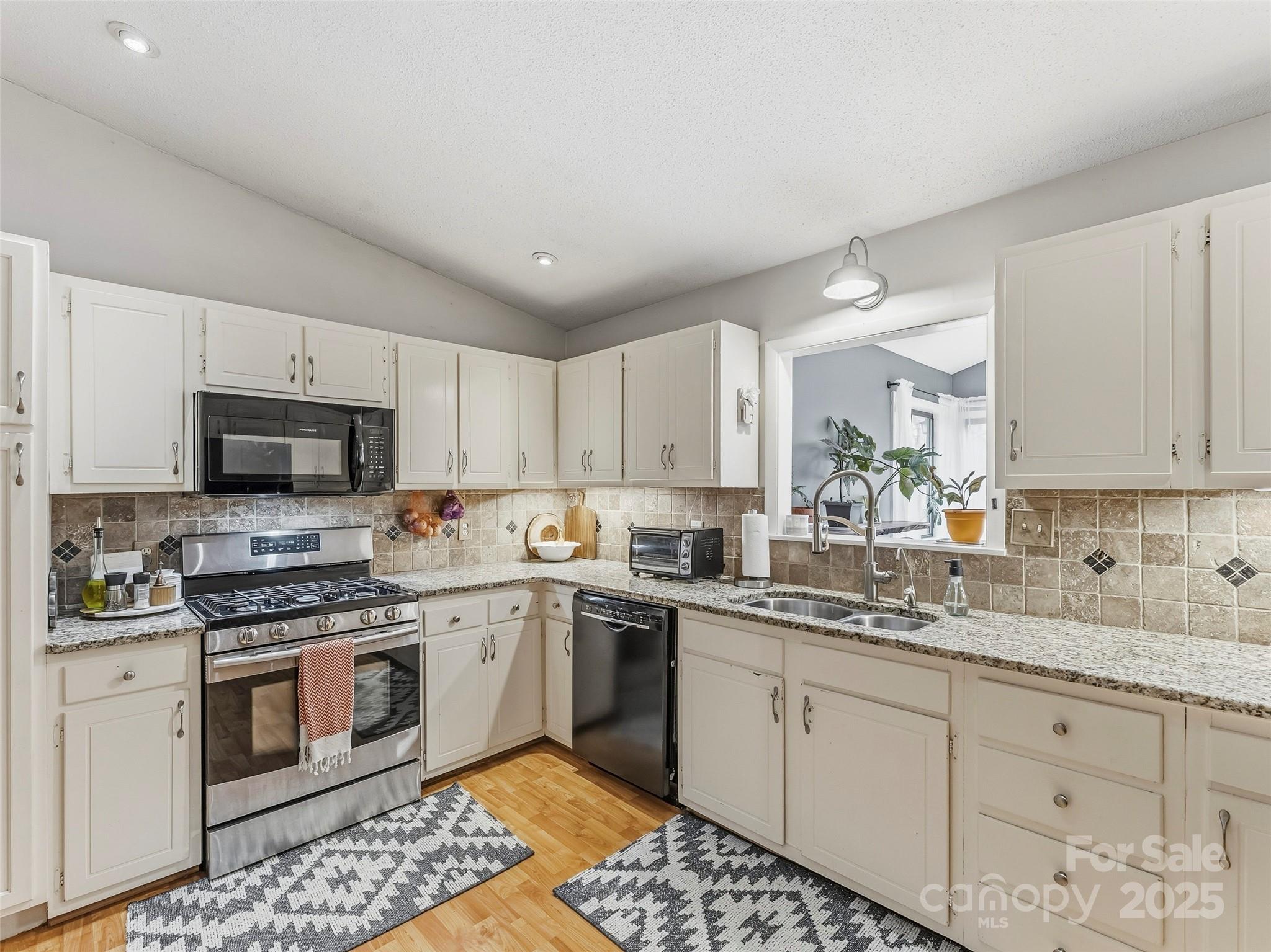 531 Three Mile Knob Road Pisgah Forest, NC 28768 - Photo 13 of 37 a kitchen with a sink stove and microwave