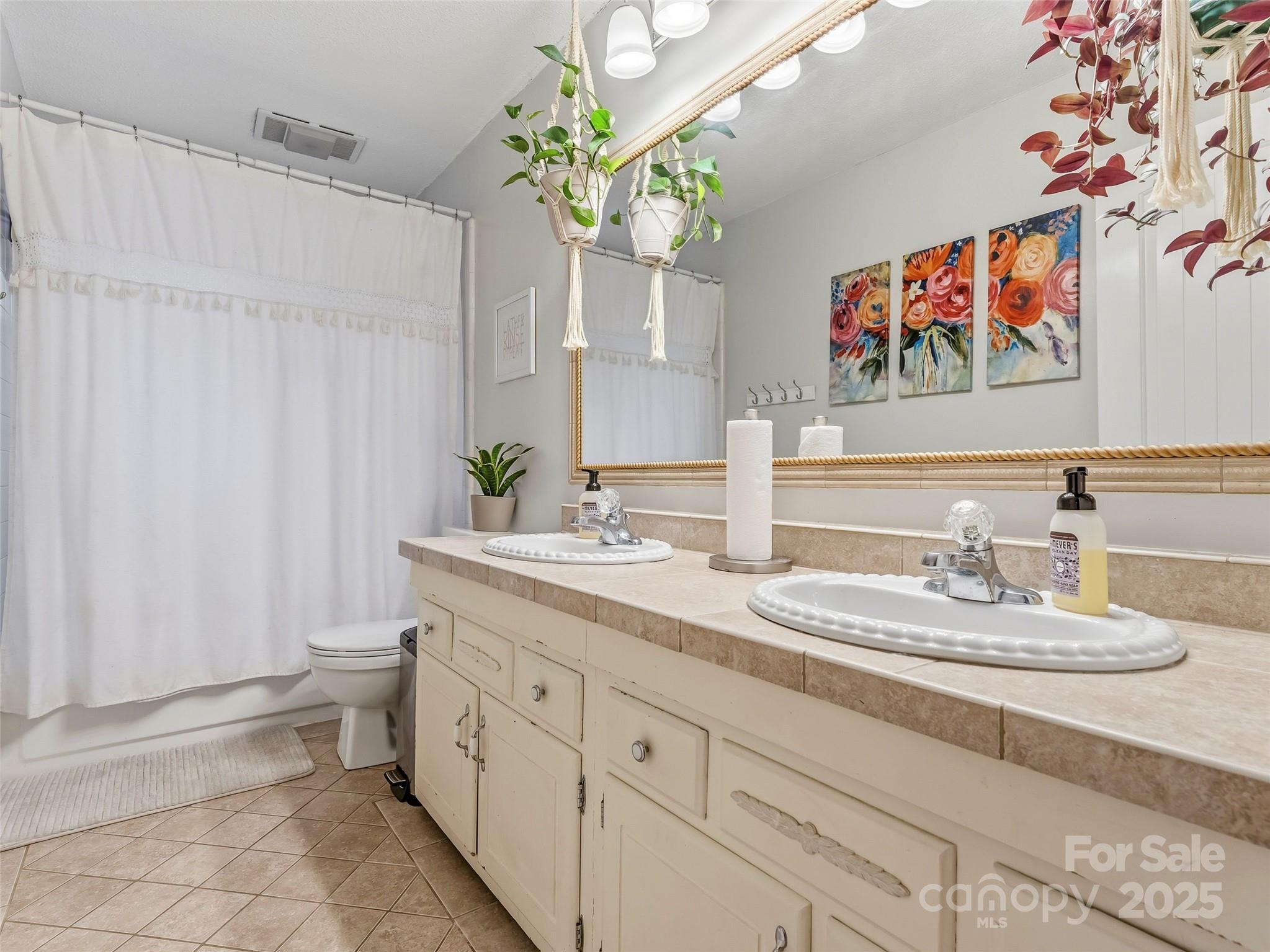 531 Three Mile Knob Road Pisgah Forest, NC 28768 - Photo 26 of 37 a spacious bathroom with a double vanity sink and a mirror