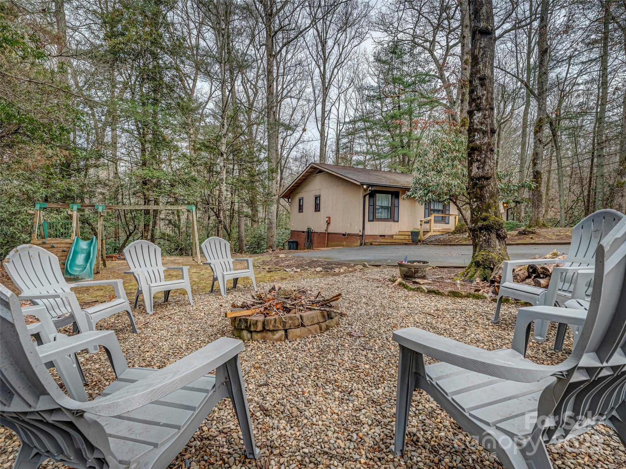 531 Three Mile Knob Road Pisgah Forest, NC 28768 - Photo 29 of 37 a view of a patio with couches chairs and wooden floor