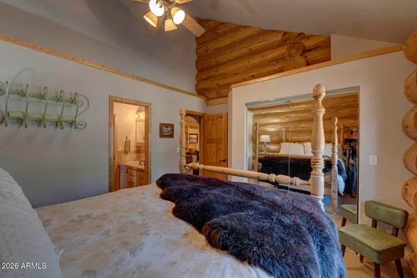 a bedroom with a bed mirror and window