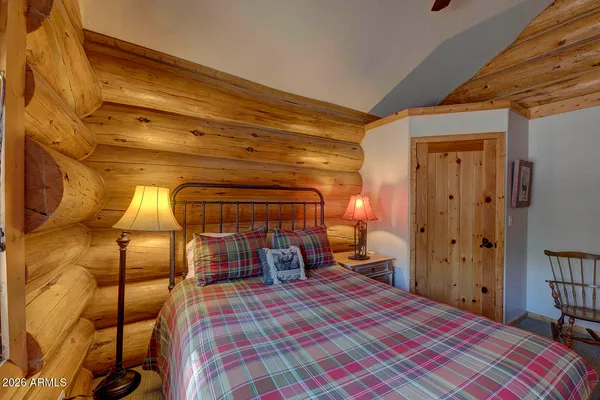 a bedroom with a bed and a mirror