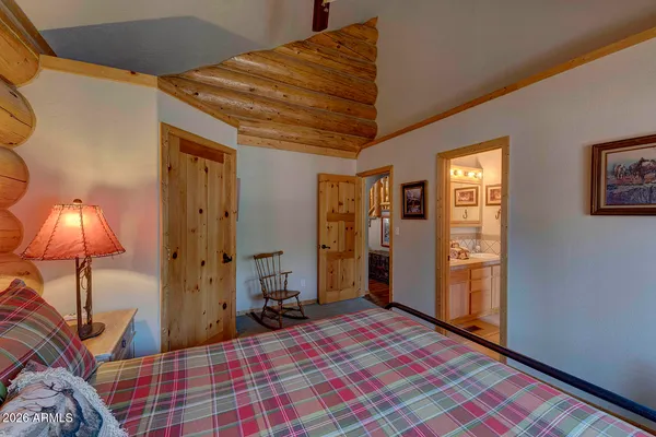 a bedroom with a bed and a lamp